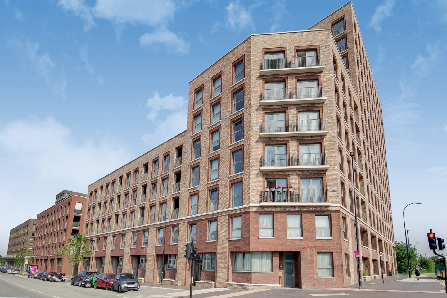 The brick facade of Gallions Point against a bright London sky